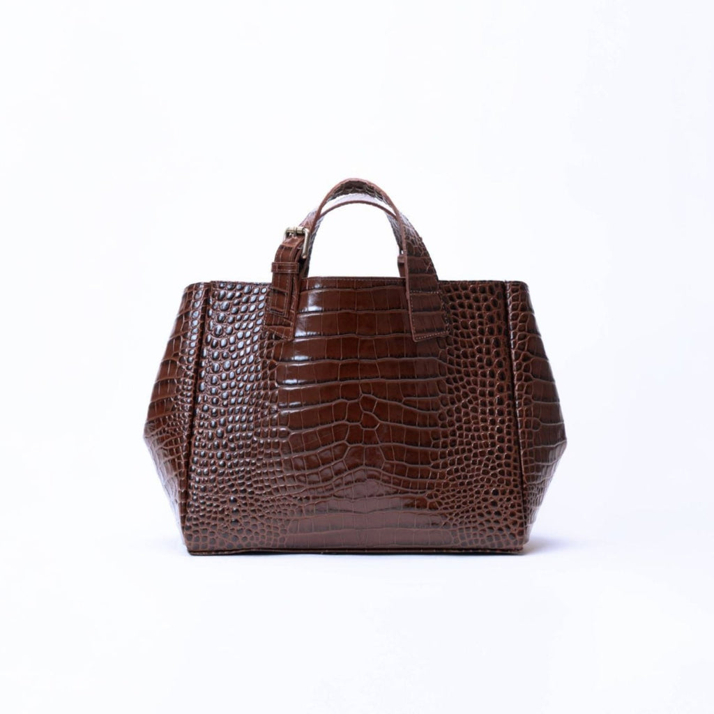 A dark brown crocodile-embossed leather handbag with dual top handles, centered on a clean white background.