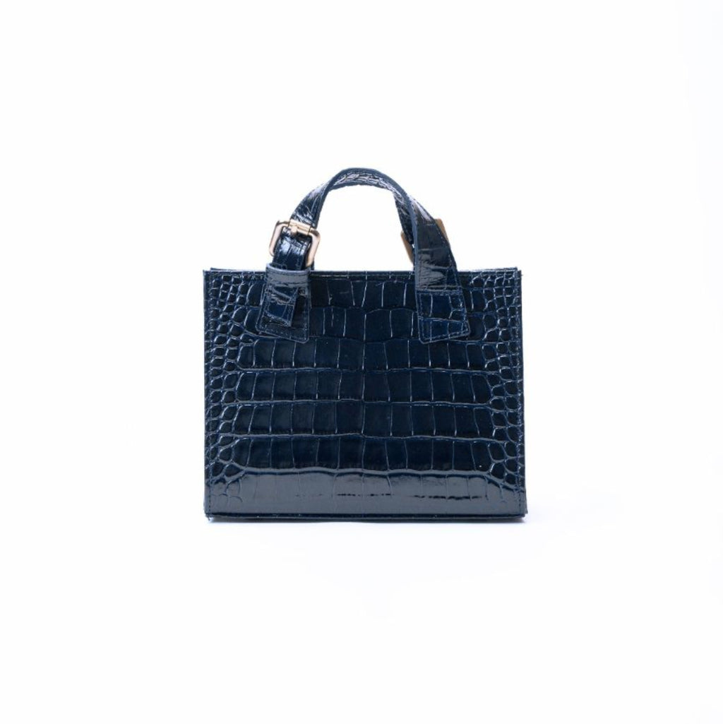 A navy blue crocodile-embossed leather handbag with top handles and a silver-tone buckle, centered on a plain white background.