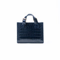 A navy blue crocodile-embossed leather handbag with top handles and a silver-tone buckle, centered on a plain white background.